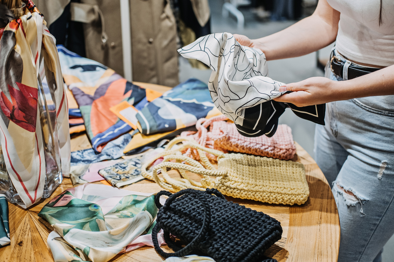 Sustainable fashion. Modern  young woman choosing vintage scarf,